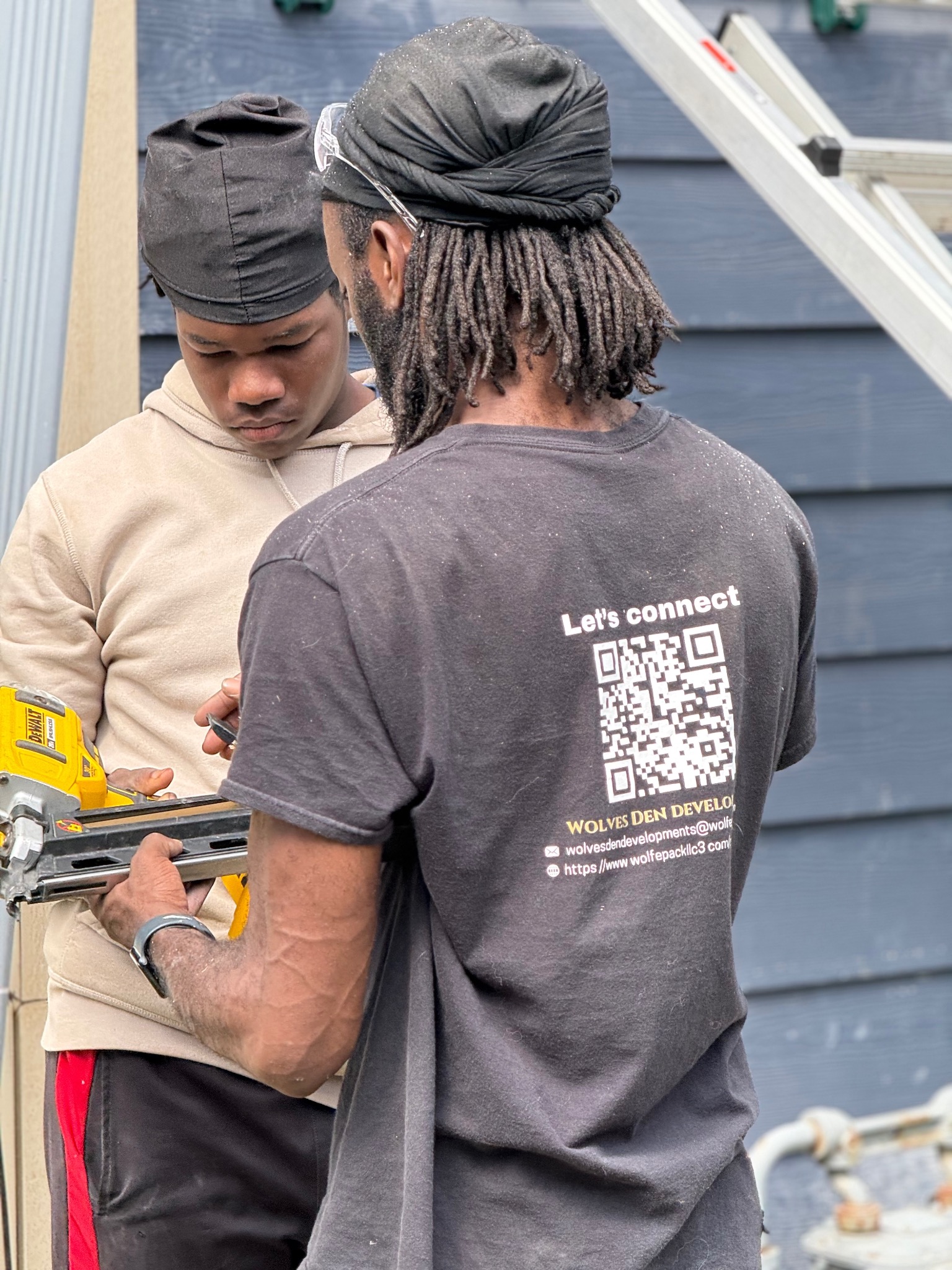 Wolves Den Developments crew working on a residential exterior project