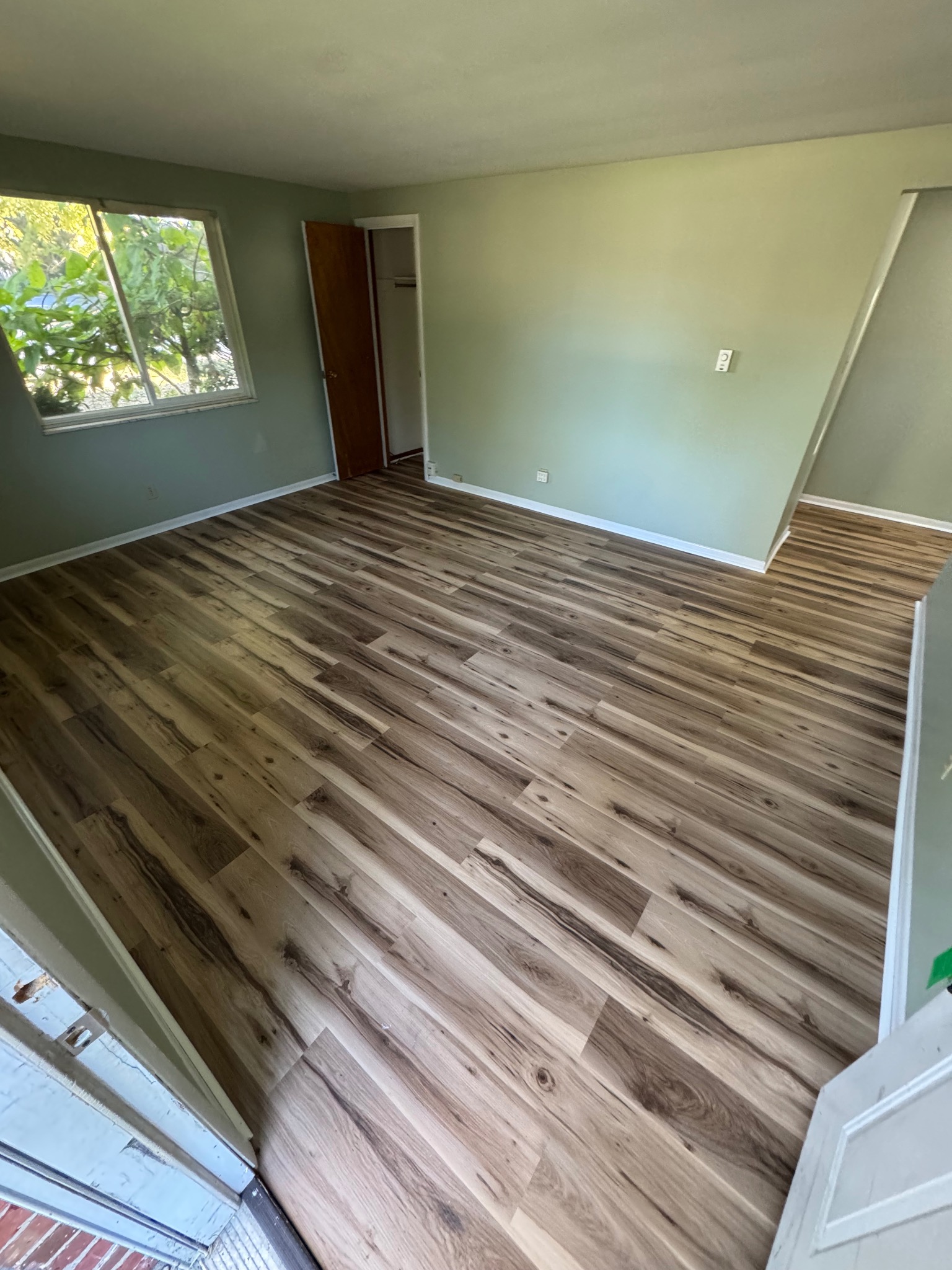 Completed luxury vinyl plank flooring installation by Wolves Den Developments