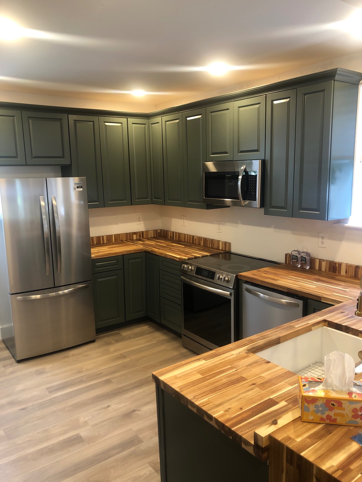 Completed kitchen cabinetry and butcher-block countertops